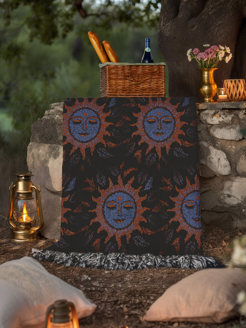 Luxurious woven cotton throw blanket featuring mystical blue sun faces with copper rays on black background, bordered by elegant fringe. Perfect celestial wall hanging, witchy bedroom decor, or dark academia throw for couch or bed.